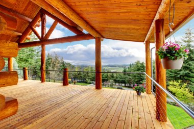 Beautiful view of the log cabin house porch. clipart