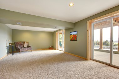 Ground level large new living room with green walls.