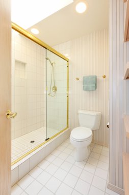 Bathroom with white tiles and glass shower clipart