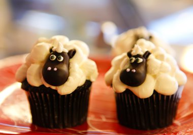 Cholocate cupcake with cow or sheep animal. clipart