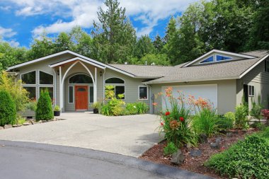 New one level home with beige walls and large garage clipart