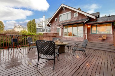 Large brown house with back deck exterior rain winter shot clipart