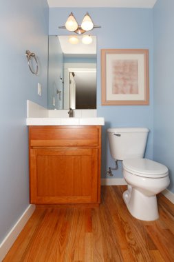 Blue bathrrom with sink and toilet clipart