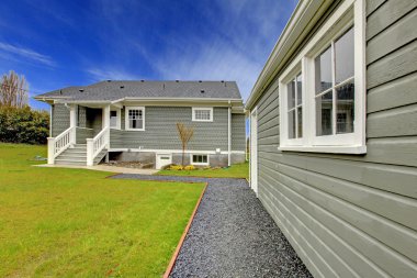 Grey house back yard and detached garage clipart