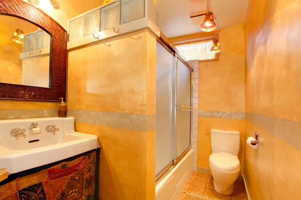 Exotic orange artistic bathroom with antique sink — Stock Photo, Image