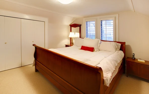 stock image Small bedroom with large brown bed