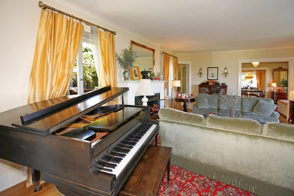 Sala de estar com grande piano e luxuosa cortina amarela — Fotografia de Stock