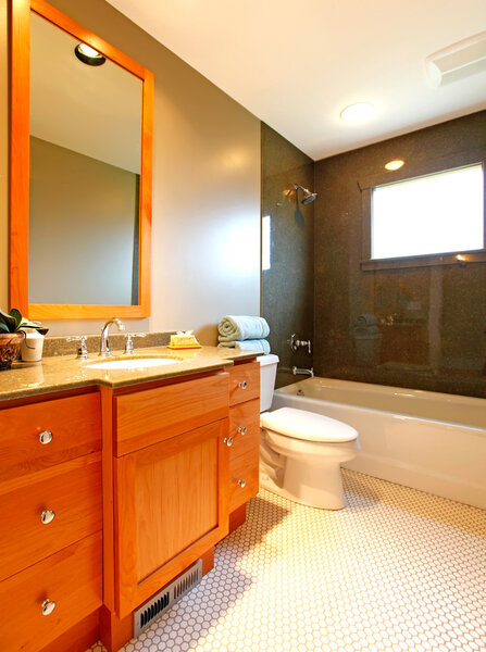 Bathroom with cherry cabinet and marble tub