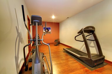 Modern home gym in the basement. clipart