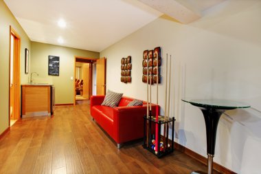 Hallway with billiard poll and red sofa near the small bar. clipart