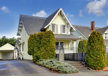 Craftsman style yellow house exterior. clipart