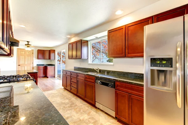 Grande cozinha brilhante com armários de cereja escura . — Fotografia de Stock