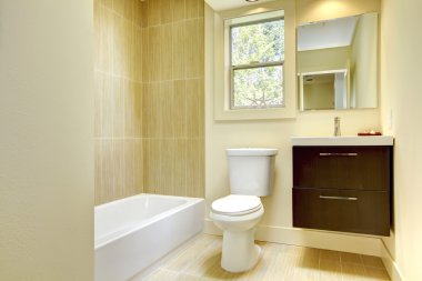 New modern yellow bathroom with beige tiles. clipart