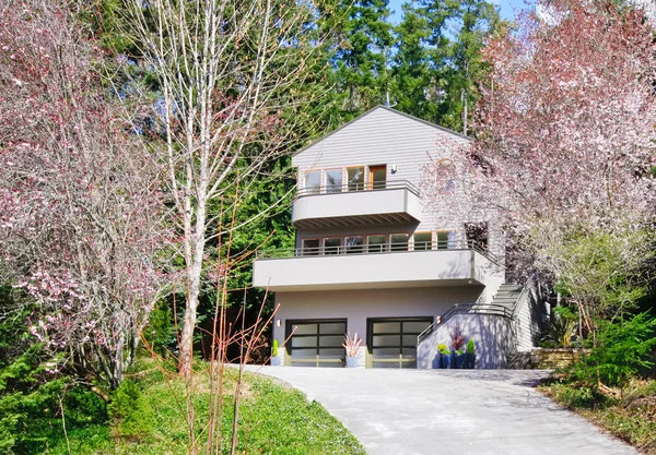 Világos barna modern ház külső tavaszi erdő. — Stock Fotó