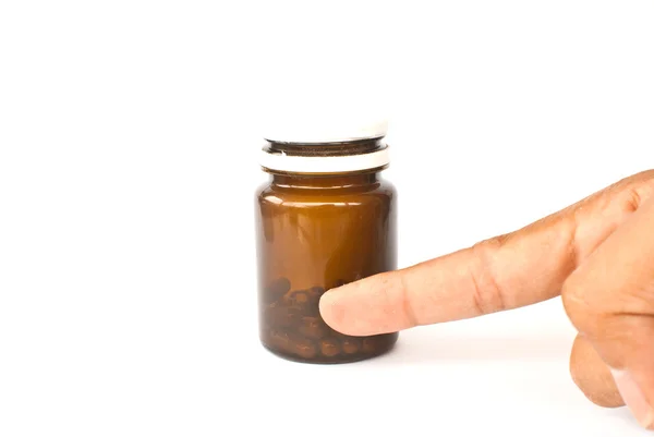 stock image Hand putting medicine isolated on the white.