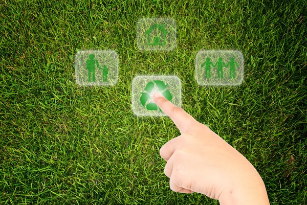 Hand pressing recycle icon on the grass field. — Stock Photo, Image