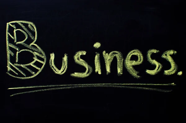 Palabra de negocios escrita a mano con tiza en una pizarra . — Foto de Stock