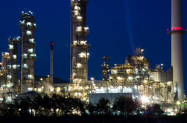 Petrochemical industry on sunset dark blue sky.