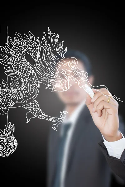 Businessman drawing Chinese Style dragon statue. — Stock Photo, Image