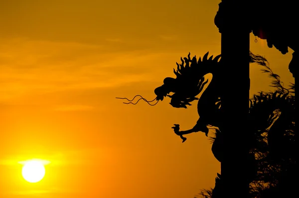 中国风格龙雕像剪影与日落. — 图库照片