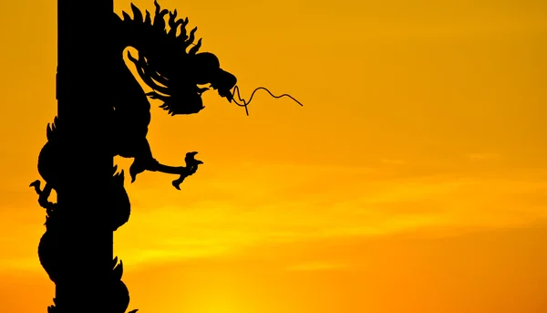 stock image Chinese style Dragon statue silhouette with sunset.