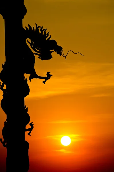 stock image Chinese style Dragon statue silhouette with sunset.