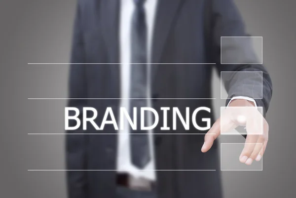Geschäftsmann drückt Branding-Wort auf Touchscreen-Oberfläche. — Stockfoto