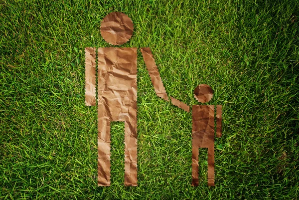 Vintage man and child symbol on the grass field.