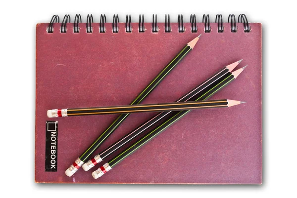 Notebook izolovaných na bílém s tužky. — Stock fotografie