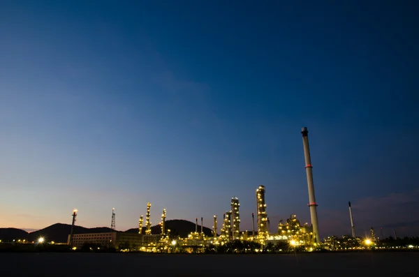 Reflection of petrochemical industry on sunset dark blue sky. Stock Photo