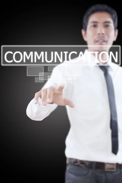 Uomo d'affari che spinge la parola Comunicazione su un'interfaccia touch screen . — Foto Stock