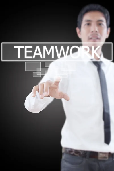 Businessman pushing Teamwork word on a touch screen interface. — Stock Photo, Image