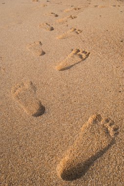 Print Foot symbol on sand texture background. clipart