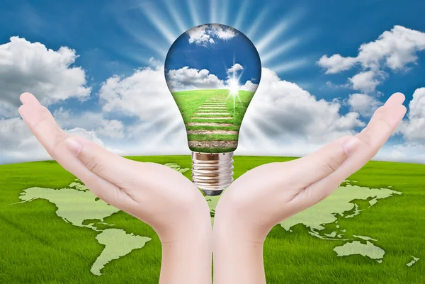 Hand putting light bulb for save world. — Stock Photo, Image