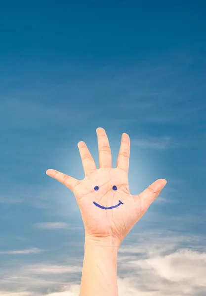 Smile on hand on the blue sky field. — Stock Photo, Image
