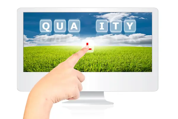 Hand pushing Quality word on monitor screen. — Stock Photo, Image