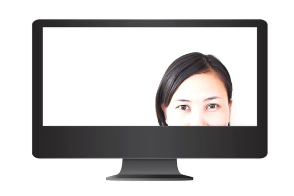 Close-up van meisje gezicht in de monitor. — Stockfoto