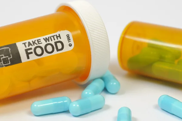 Blaue Pillen und Tablettenflasche — Stockfoto