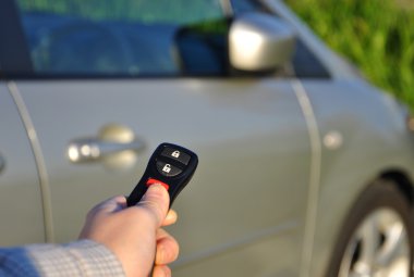 A hand holding car keys clipart