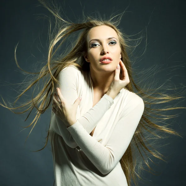 Fashion portrait of beautiful woman with streaming hair — Stock Photo, Image