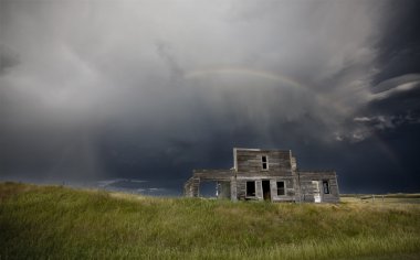 Storm over abandoned farm house clipart