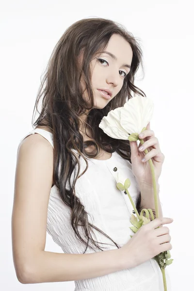 Portrait of a beautiful girl in white with a flower — Stock Photo, Image
