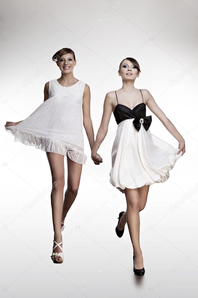 Portrait of two beautiful girls in dresses