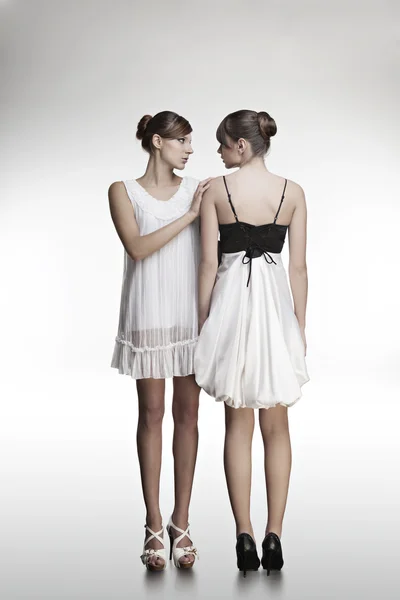 Portrait of two beautiful girls in dresses — Stock Photo, Image