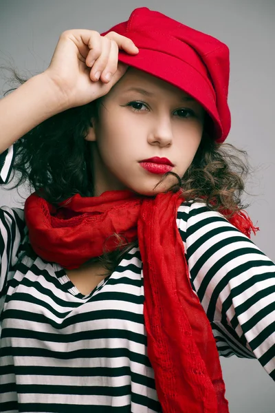 Portrait of a beautiful girl with bright makeup, a scarf in a cap — Stock Photo, Image