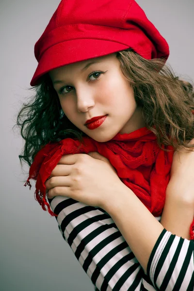 Portrait of a beautiful girl with bright makeup, a scarf in a cap — Stock Photo, Image