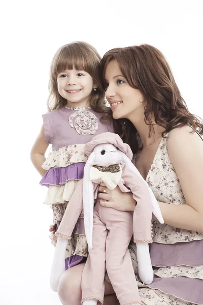 Portrait of mother and little daughter with a toy — Stock Photo, Image