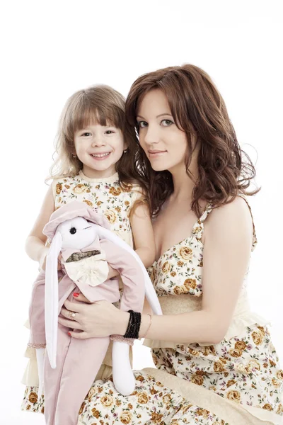 Portrait of mother and little daughter in his arms with a toy — Stock Photo, Image