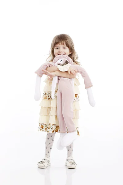 Porträt eines lächelnden kleinen Mädchens, das mit einem Spielzeughasen spielt — Stockfoto