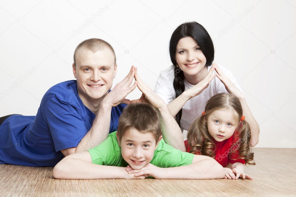 Portrait of a beautiful family: parents and children play together